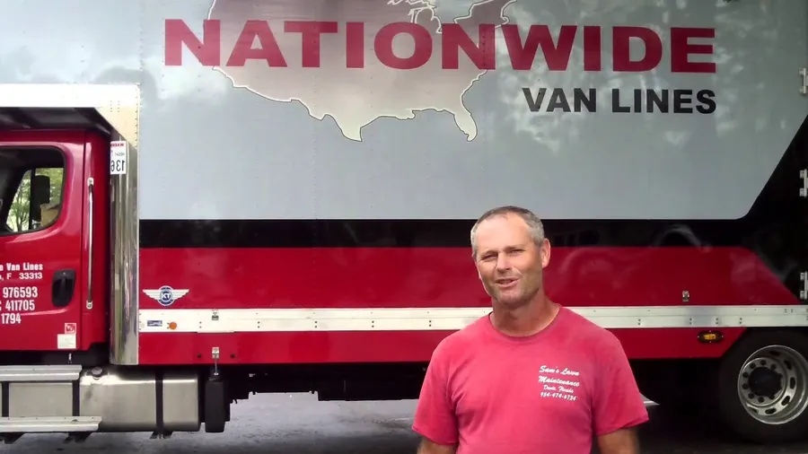 Customer in front of the red Nationwide Van Lines tractor trailer