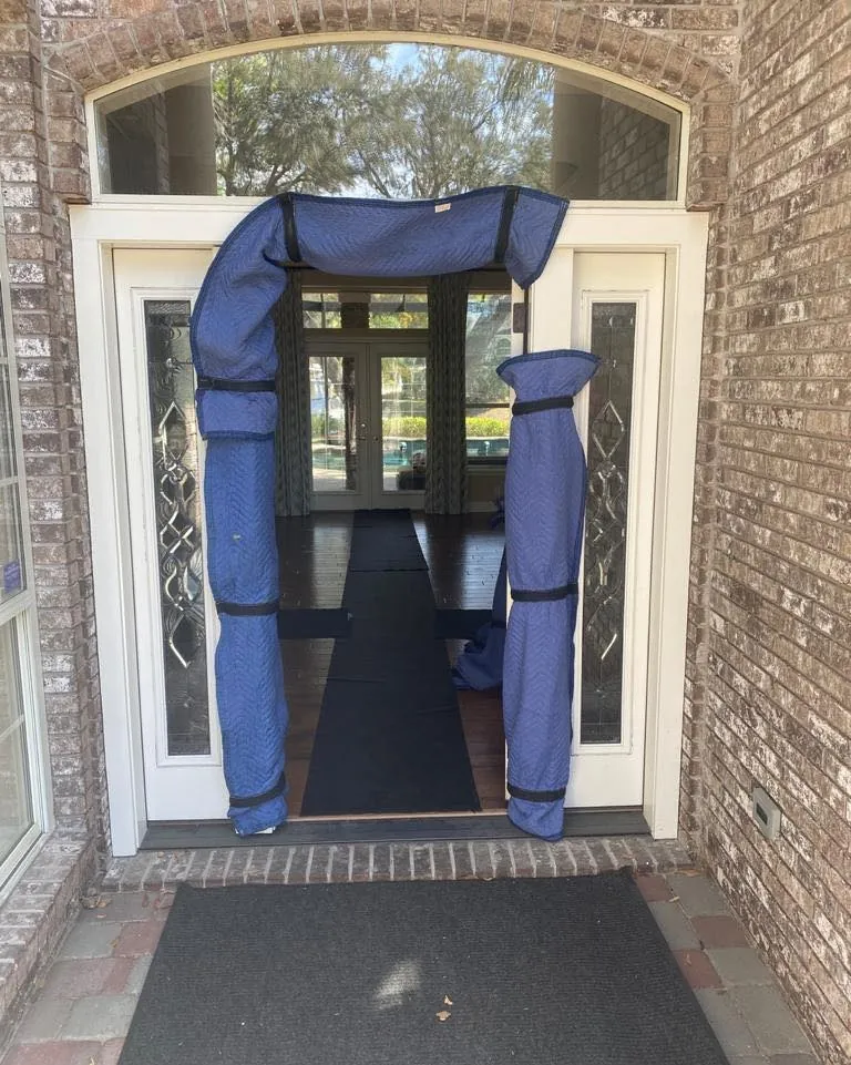 Front doorway protected with padded door jamb guards and a floor runner